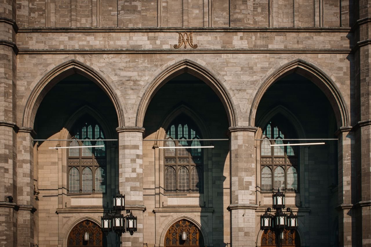 why-choose-us Facade of the Gothic Revival Notre-Dame Basilica in Montreal, showcasing elegant arches and intricate design.